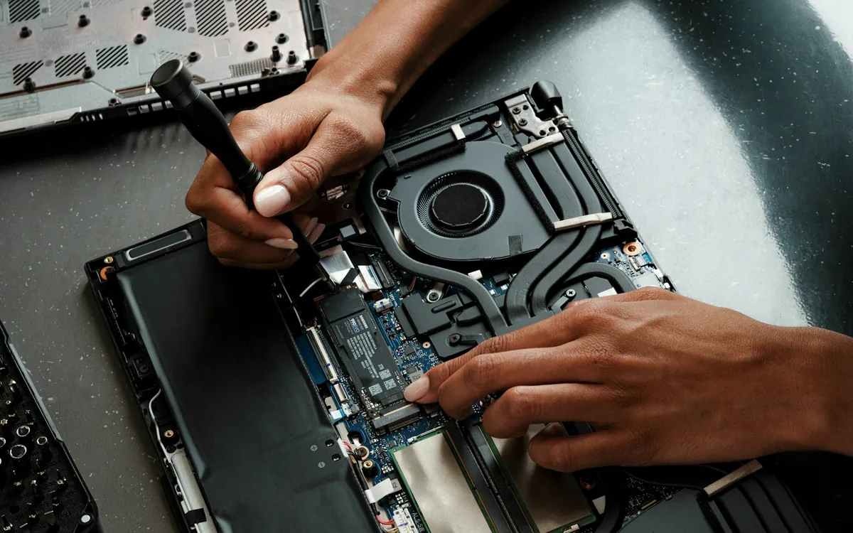 Technician repairing a laptop — appointments in the Waterdown area